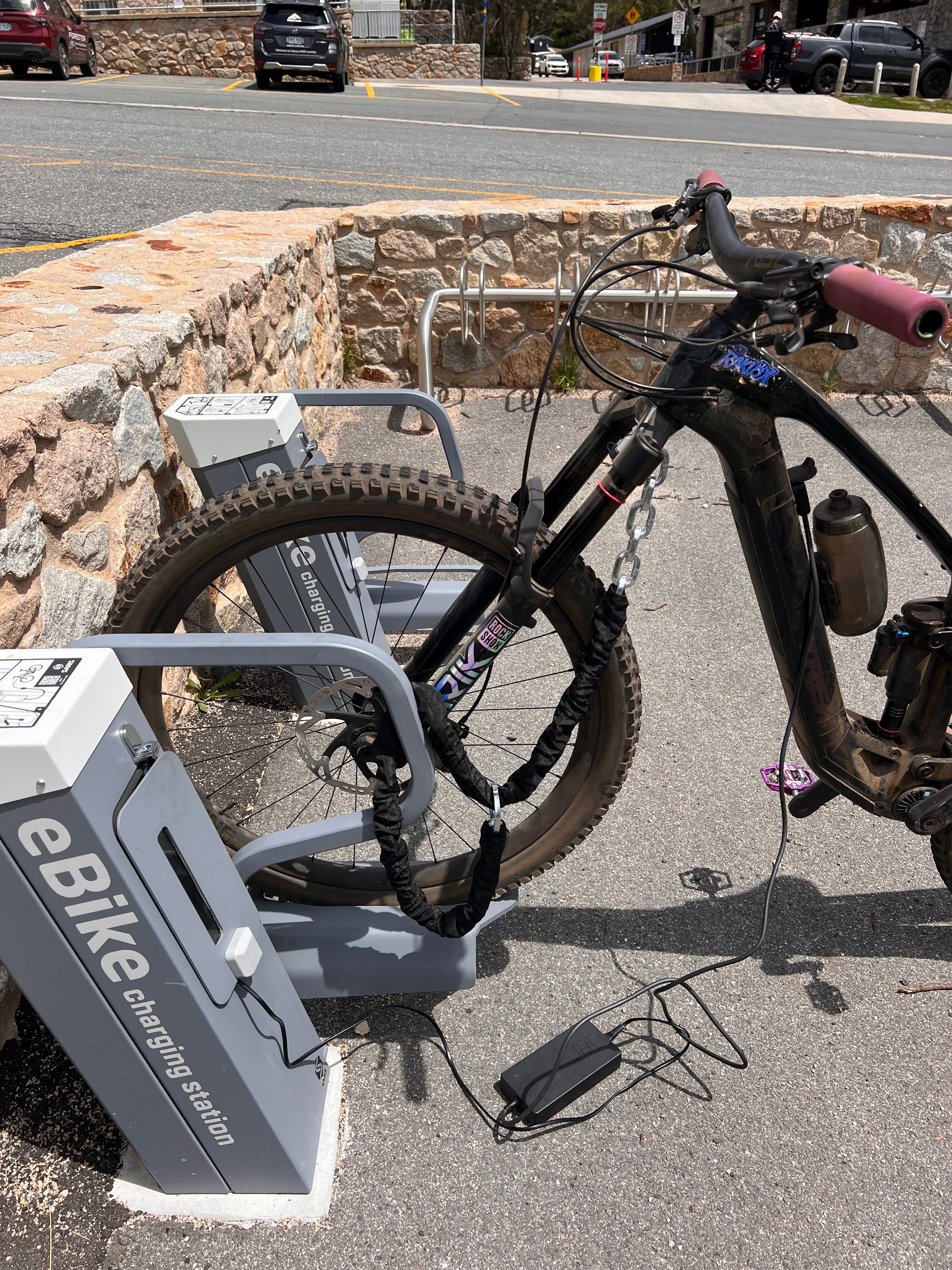 E-Bike Charging Outdoors While Locked to Bike Rack Using Travel Loop Bike Security Chain