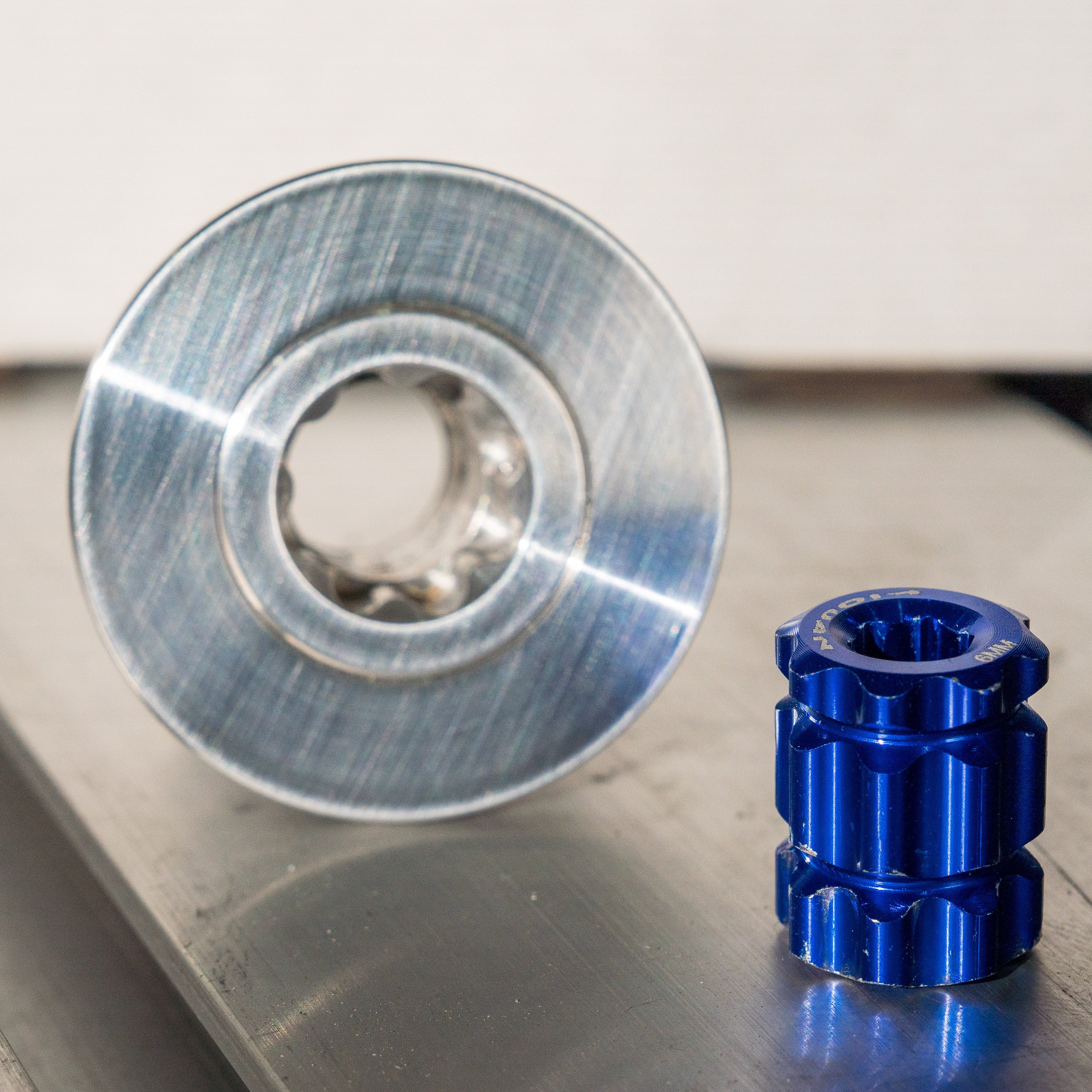 Metallic blue and silver mechanical components on a reflective surface of the anchor point